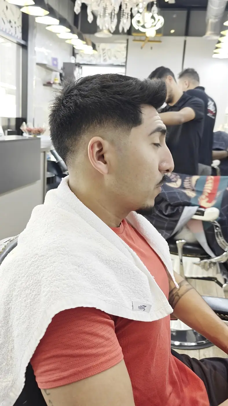 A client with a fresh skin fade in the barber chair