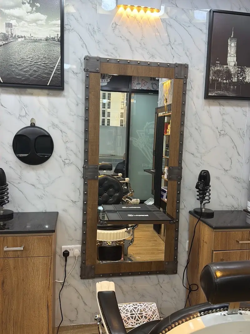 A barber station with mirror and grooming products